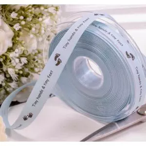15mm blue taffeta ribbon with the words tiny hands and tiny feet print along the length of one side of the ribbon,